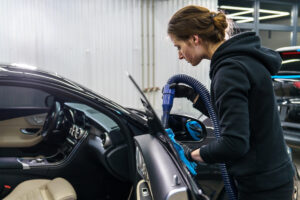 Xtreme auto detailing worker detailing a car in Austin TX
